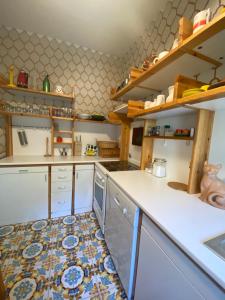 a kitchen with a white counter top and some dishes at La Casa di Renata by PortofinoVacanze in Rapallo