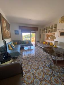 a living room with a couch and a television at La Casa di Renata by PortofinoVacanze in Rapallo