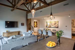 a living room with blue couches and a table at Elevation Lofts Hotel in Asheville
