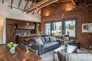 a living room with a couch and a table at Elevation Lofts Hotel in Asheville