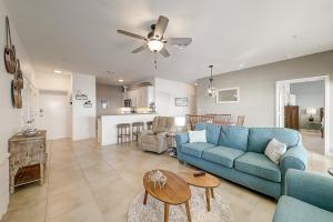 a living room with a blue couch and a table at Sand Dollar Unit C3 in Rockport