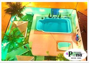 an overhead view of a swimming pool in a resort at Pousada Pena in Mucuri
