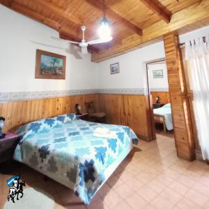 1 dormitorio con cama y techo de madera en Don Romulo en Tupungato
