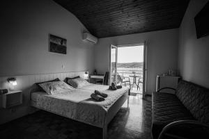 a bedroom with a bed with two shoes on it at B&B Sobe Lušina in Sečovlje