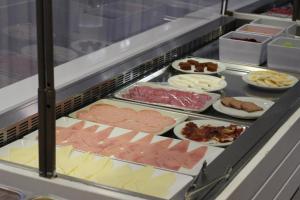 a buffet line with different types of meats and cheeses at TC Apartamentos Dorotea in Playa del Ingles