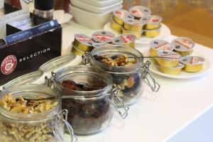 a table topped with jars of nuts and desserts at TC Apartamentos Dorotea in Playa del Ingles