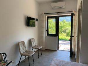 two chairs in a room with an open door at Panorama rooms in Bovec