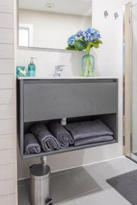 ein Badezimmer mit einem Waschbecken und Handtüchern darunter in der Unterkunft Dimore Italiane - Boutique Apartments in Corralejo