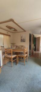 a living room with a wooden table and benches at Zacisze nad Sanem 129 a in Załuż
