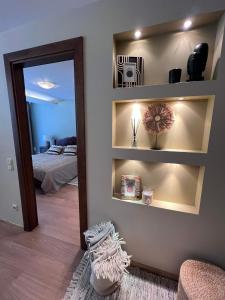 a room with a mirror and a bedroom with a bed at Apartamentai Forest green in Nida