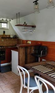 a kitchen with a table and chairs in a kitchen at Planinska vikendica LUCIJA in Fužine