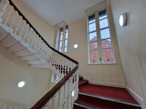 a staircase in a house with a window at Birch Hill Clock Tower in Rochdale