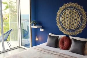 a blue bedroom with a bed and a large window at SUNSET ART Beach Front in Chernomorets