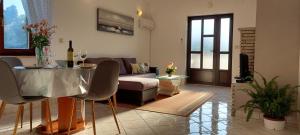 a living room with a table and a couch at Green Villa in Banjole
