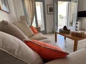 a living room with a couch and a table at Bakagiannis Apartments in Parga