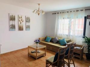 a living room with a couch and chairs and a table at Lin House in Corralejo