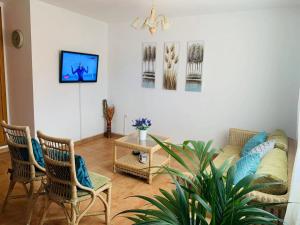 a living room with a couch and two chairs at Lin House in Corralejo