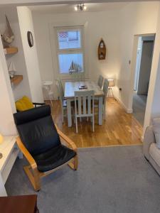 a dining room and living room with a table and chairs at Eleven Upway Street in Weymouth