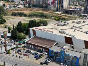 an overhead view of a building with a parking lot at Studio apartment with balcony in Tbilisi in Tbilisi City