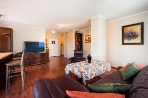 Televízia a/alebo spoločenská miestnosť v ubytovaní Arkadia Homely Apartament
