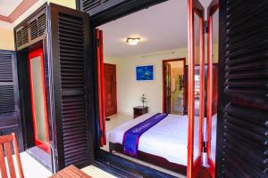 Postel nebo postele na pokoji v ubytování Harmony Hoian Homestay