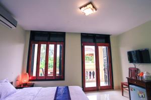 Postel nebo postele na pokoji v ubytování Harmony Hoian Homestay