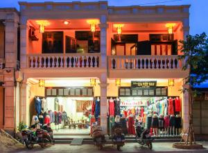 a store with motorcycles parked in front of it at Harmony Hoian Homestay in Hoi An