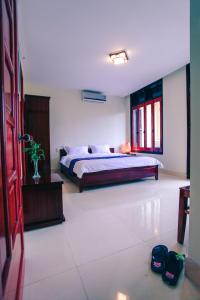 Postel nebo postele na pokoji v ubytování Harmony Hoian Homestay