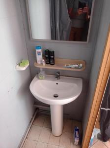 ein Badezimmer mit einem weißen Waschbecken und einem Spiegel in der Unterkunft Chambre meublée indépendante, avec piscine et jardin, 1 lit pour 2 personnes in Toulouse