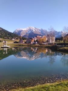 a large body of water with mountains in the background at Studio au calme face aux montagnes dans station de ski in La Morte