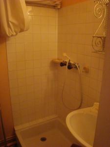 a bathroom with a shower and a tub and a sink at Studio au calme face aux montagnes dans station de ski in La Morte