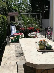 a patio with a table and chairs and plants at Villa Maslina in Zadar