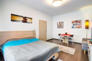 a bedroom with a bed and a table at Károlyi street - central location quiet place 2ppl in Budapest