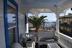 a porch with chairs and a view of the ocean at Hotel Catalina in Avalon