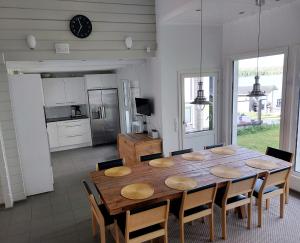 a dining room with a wooden table and chairs at Chalet Norva in Rovaniemi +42 photos