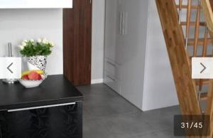 a kitchen with a table with a bowl of fruit on it at Apartament Magnolia przy morzu in Międzyzdroje