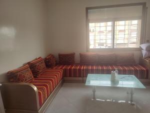 a living room with a couch and a table at STOPOVER 1 MIDELT in Midelt