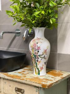 a vase on a table with a plant in it at Apartments Kremenic in Cres +50 photos
