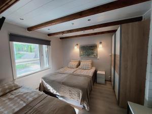 a bedroom with two beds and a window at Chalet Norva in Rovaniemi