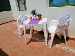 a white table and two chairs sitting on a patio at FuerteSun Dunas beach in Parque Holandes