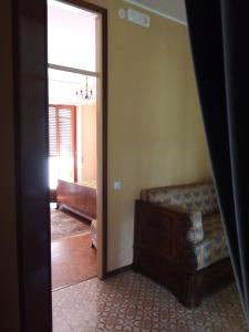 a living room with a couch and a window at La Séca - Antico Albergo Alzese in Pella