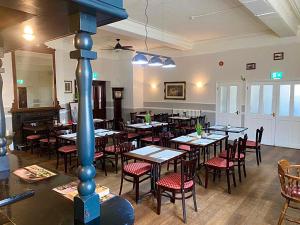 a restaurant with tables and chairs in a room at Royal Hotel Sheerness in Sheerness +8 photos
