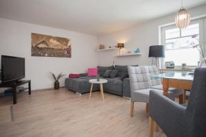 a living room with a couch and a table at Ferienwohnung Mia in Winterberg