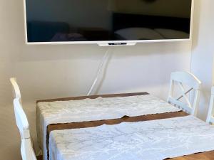 a bed in a room with a tv on the wall at City Apartment Kuopio in Kuopio