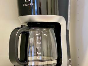 a coffee pot sitting on top of a microwave at City Apartment Kuopio in Kuopio