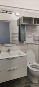 a white bathroom with a toilet and a sink at Cà Miciàt in Cervia +31 photos