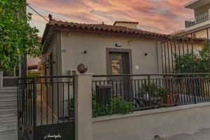 a house with a balcony with a fence at Music Reflections Apartment near Nafplio in Nea Kios