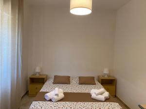 a bedroom with two beds and two night stands at Casamare San Giorgio 2 in Sciacca