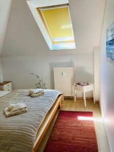 a bedroom with a bed with a skylight at FEWO VI Villa Nicole Hafenstraße 37 in Zingst