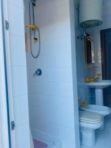 a bathroom with a toilet and a sink at Casamare San Giorgio 2 in Sciacca +19 photos